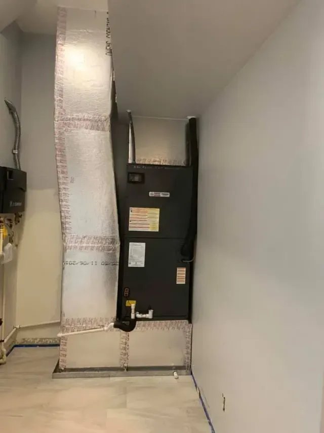 Indoor air handler with insulated ductwork in a utility closet